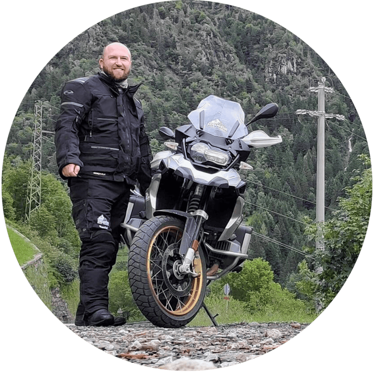 Nick Palmer standing next to a motorcycle.