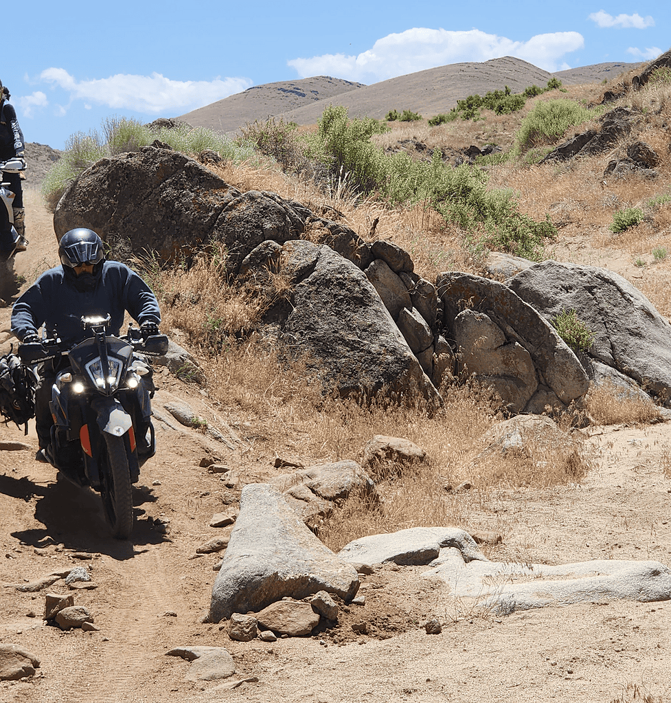 Motorcycles riding down a hill during Bret Tkacs Idaho Adventure Training